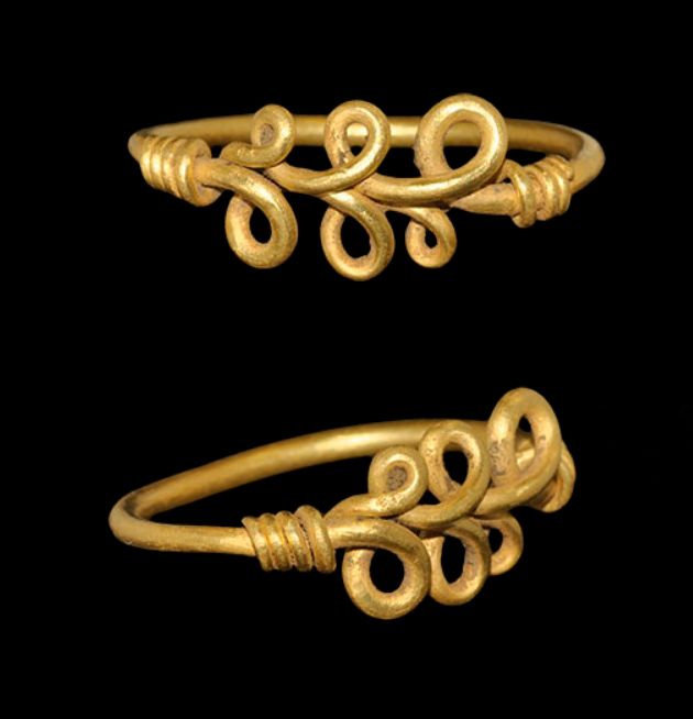 VIKING GOLD LOOPED BEZEL RING_ 9th-11th century C.E. A round-section gold hoop with tapering ends forming a running scroll and coiled about the shank VIKING GOLD LOOPED BEZEL RING_ 9th-11th century C.E. A round-section gold hoop with tapering ends forming a running scroll and coiled about the shank