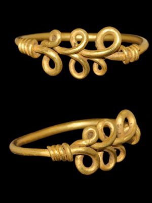 VIKING GOLD LOOPED BEZEL RING_ 9th-11th century C.E. A round-section gold hoop with tapering ends forming a running scroll and coiled about the shank